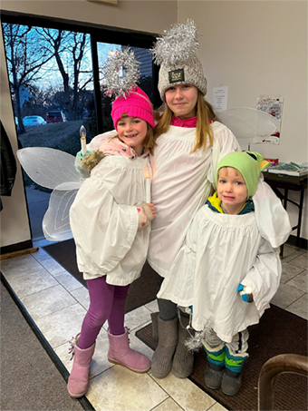 three children dressed as angels